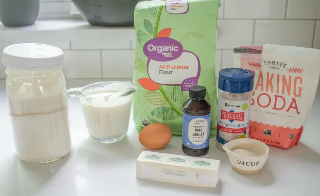 All of the ingredients needed to make my sourdough discard waffles recipe laid out on a white countertop.' title='Sourdough Discard Waffles Recipe