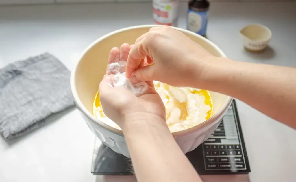 Breaking up the clumps of baking soda in your hand.' title='Sourdough Discard Waffles Recipe