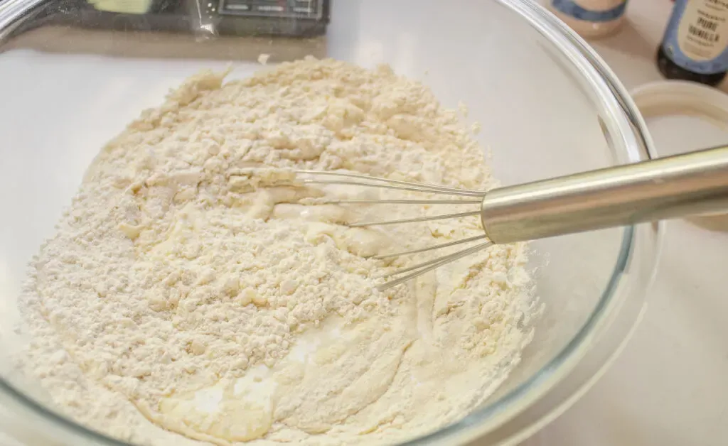 Mixing together the starter with the flour buttermilk and sugar. ' title='Sourdough Discard Waffles Recipe