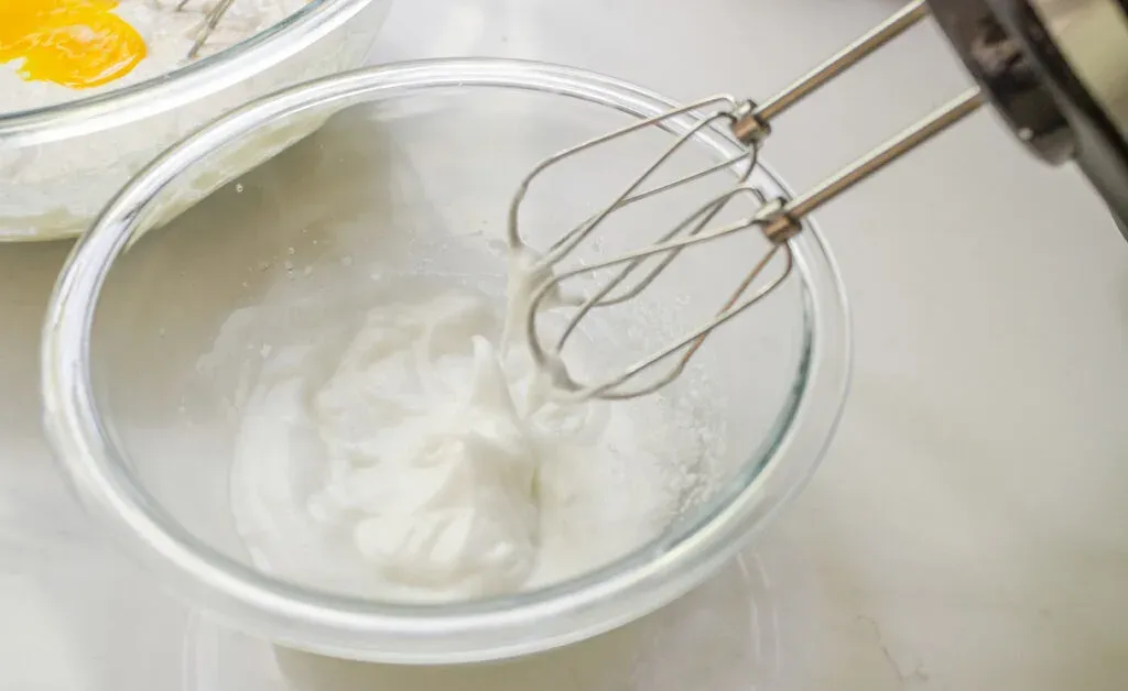 Beating the egg whites separately to fold into the sourdough discard waffle batter.' title='Sourdough Discard Waffles Recipe