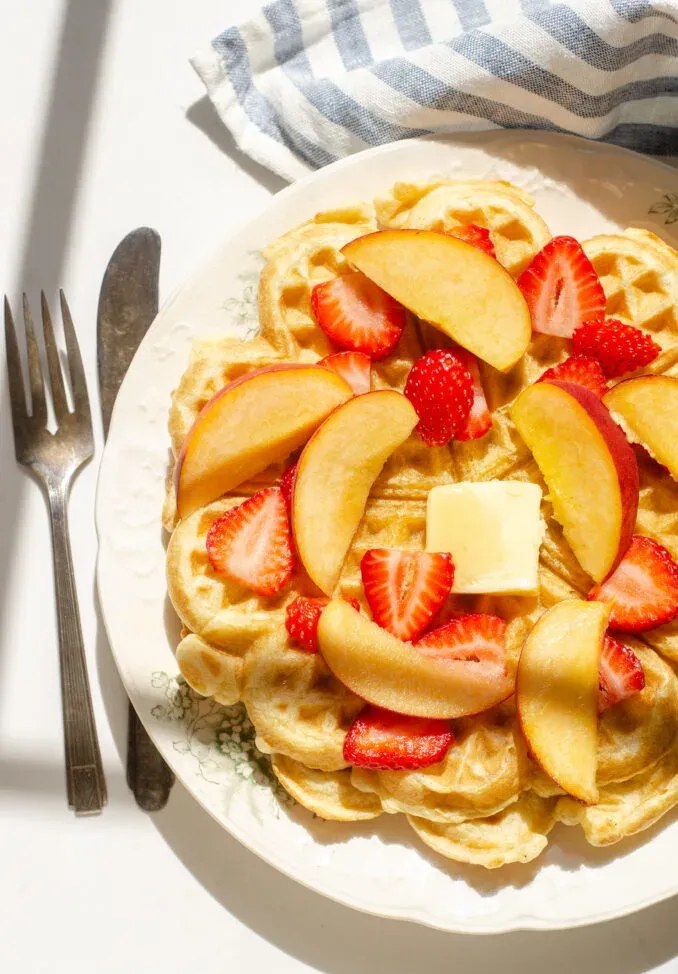 Sourdough discard waffles topped with peaches and strawberries.' title='Sourdough Discard Waffles Recipe