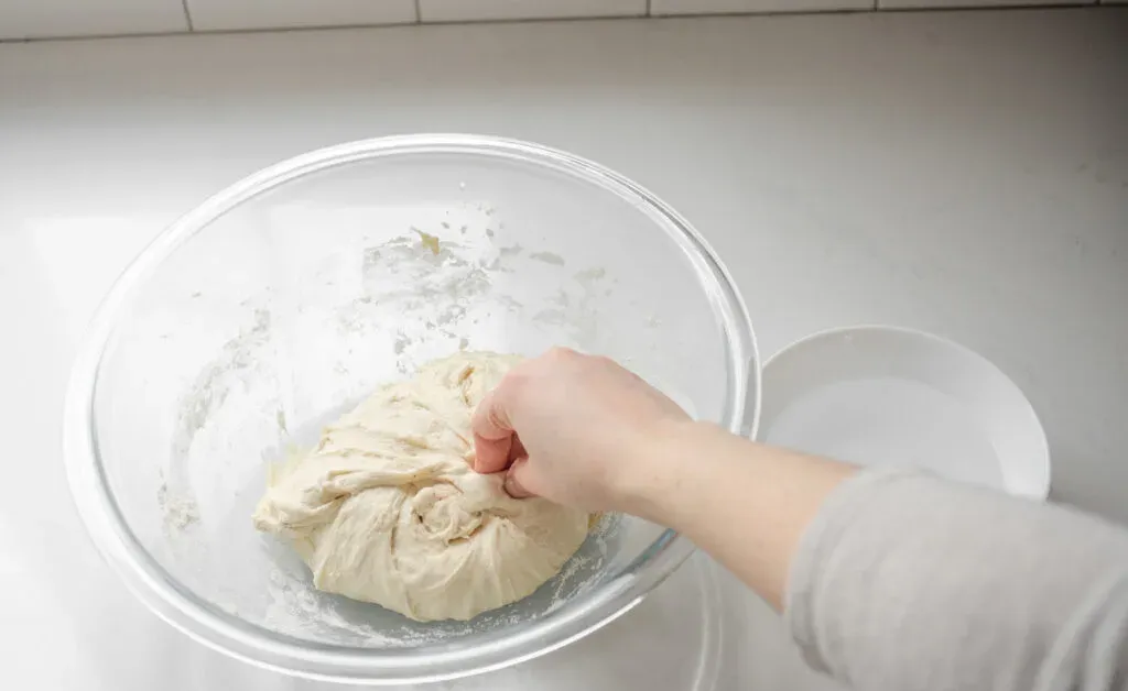 Pinching the salt into the dough.' title='Sourdough Pizza Crust Recipe