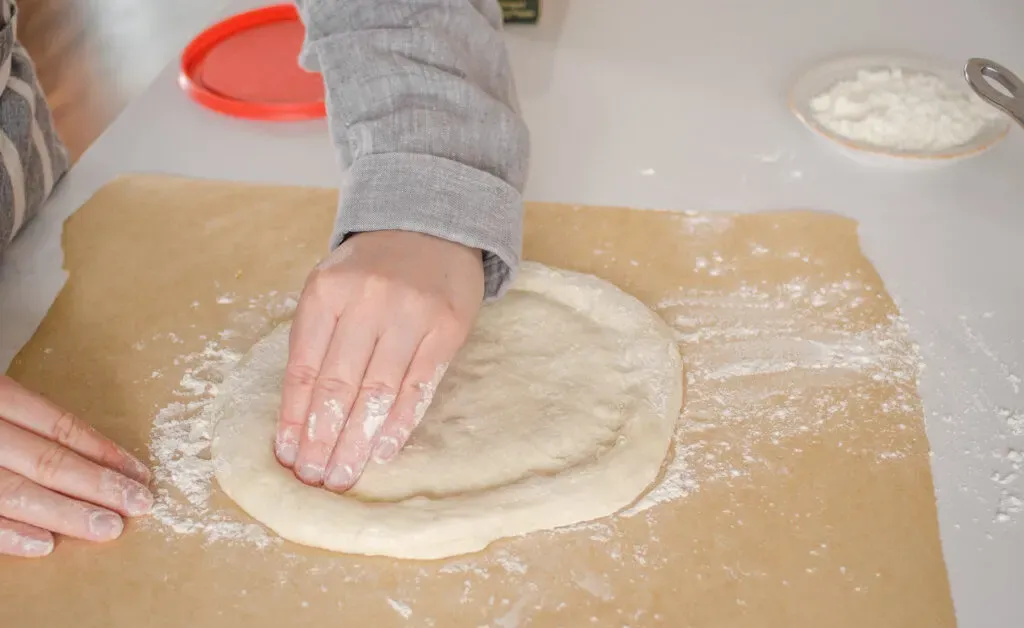 Stamping the edge of the dough.' title='Sourdough Pizza Crust Recipe