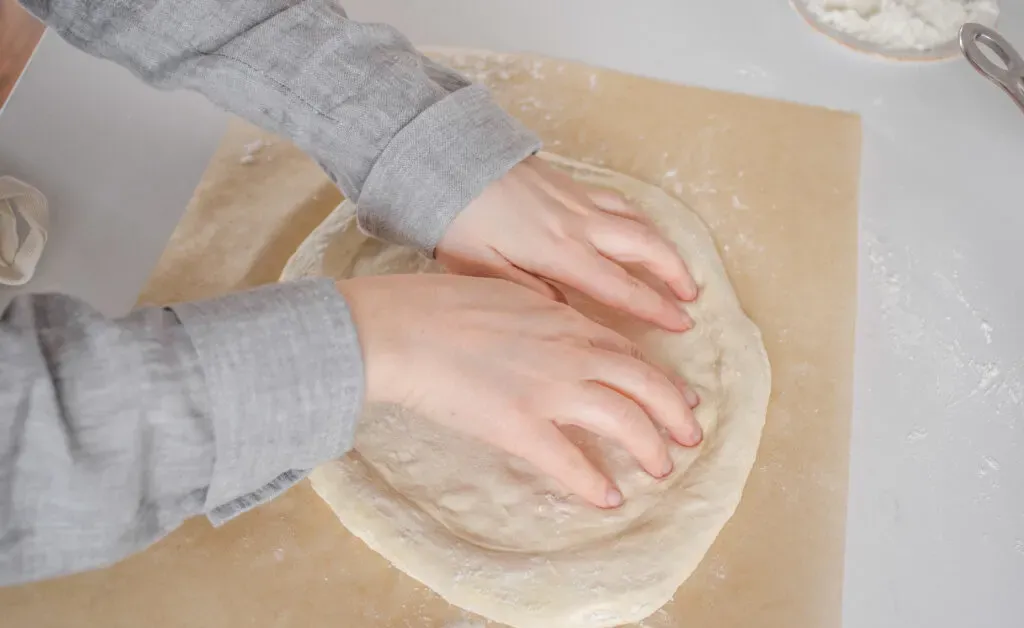 Shaping the dough after it’s had a chance to rest.' title='Sourdough Pizza Crust Recipe