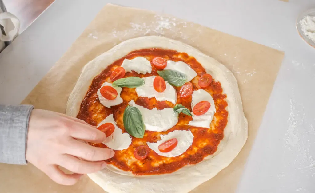 Making a Neapolitan pizza with fresh tomatoes fresh mozzarella cheese and basil. ' title='Sourdough Pizza Crust Recipe