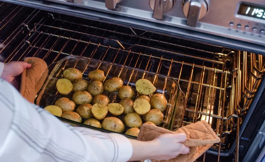 Placing the potatoes in the oven to par bake. ' title='Roasted Little Potato Recipe