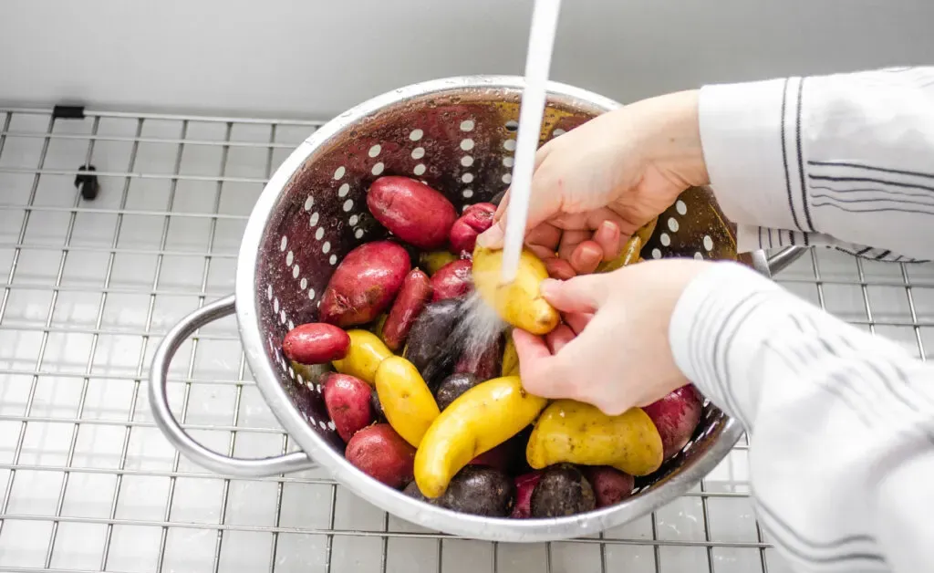 Washing the little potatoes in preparation for roasting in the oven.' title='Roasted Little Potato Recipe