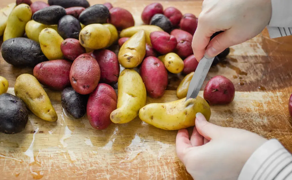 Cutting out the eyes and blemishes.' title='Roasted Little Potato Recipe