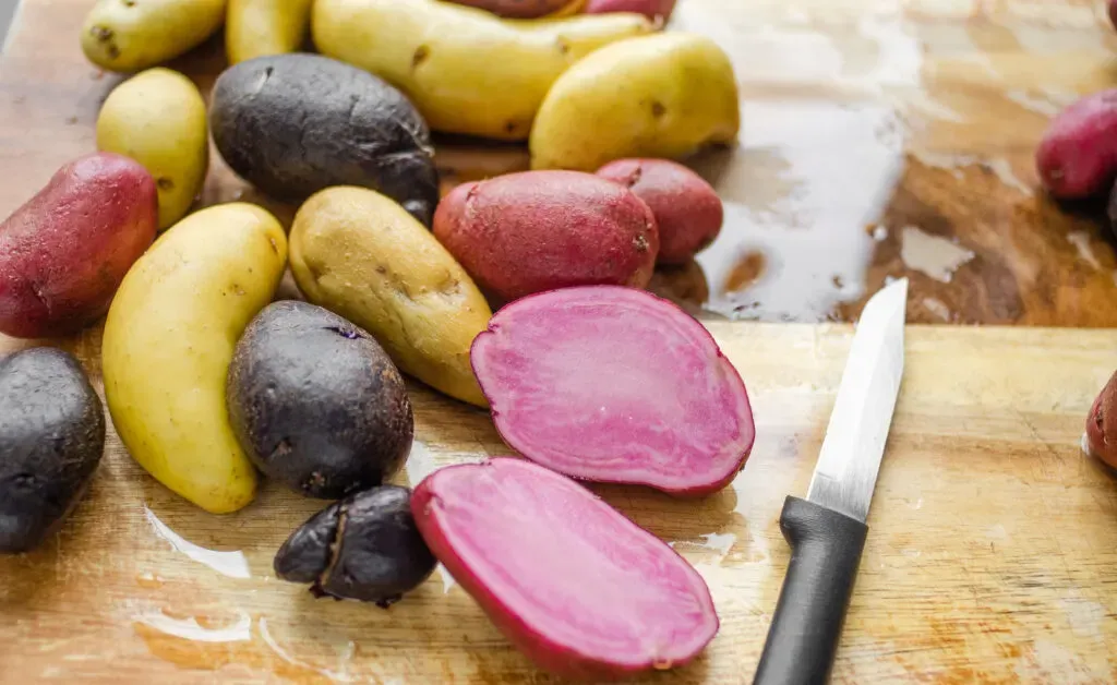 Slicing the larger fingerling potatoes in half. ' title='Roasted Little Potato Recipe