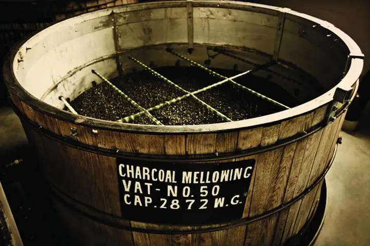A sepia-toned photo of a large vat labeled 