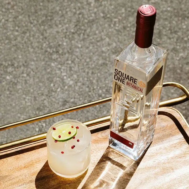 Square One Botanical vodka bottle on a tray next to a cocktail