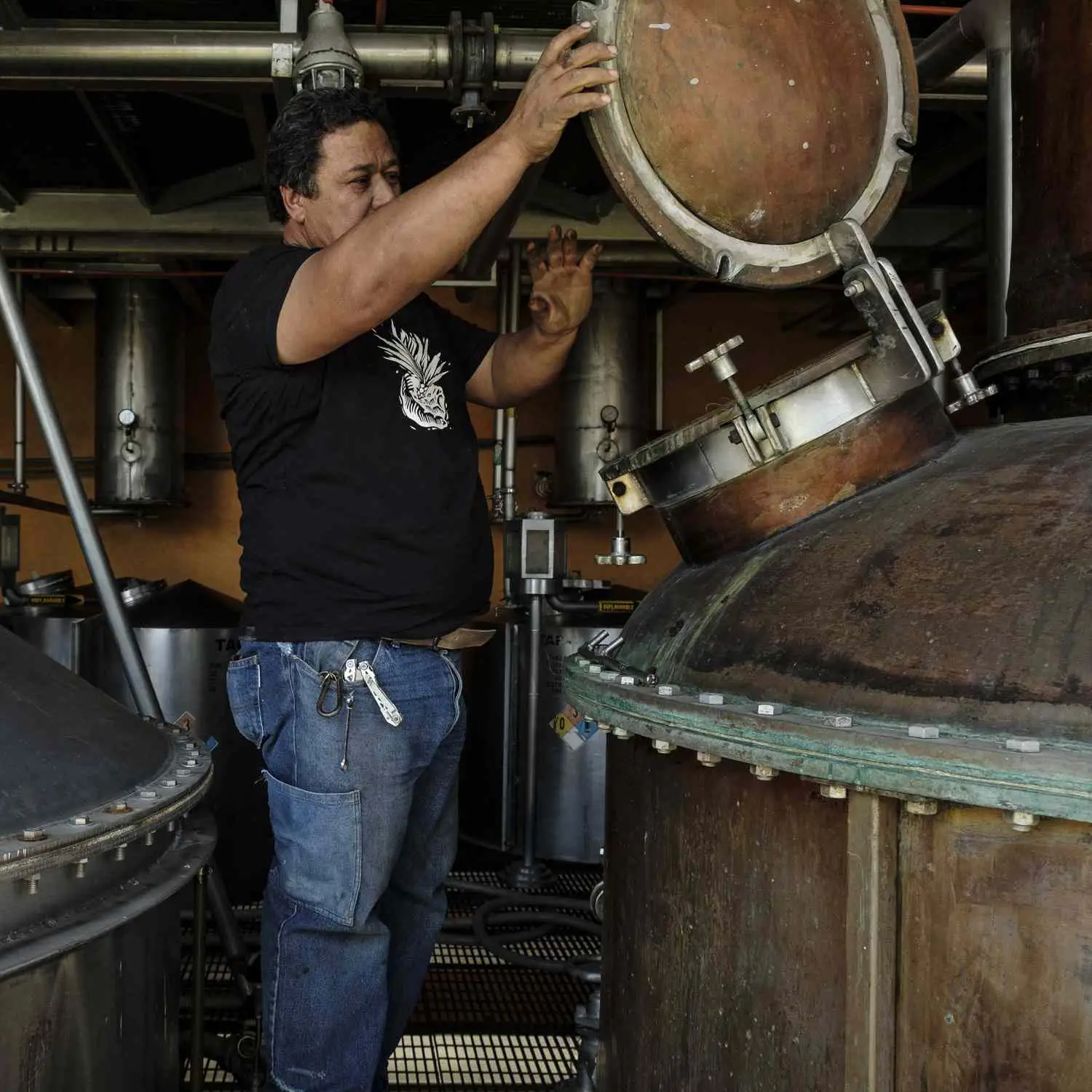 Don Fulano distillery employee Don Pancho checks the stills