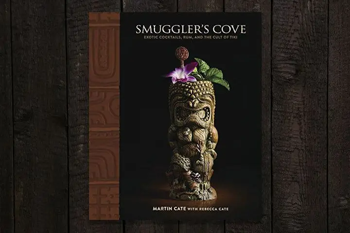 Smuggler’s Cove book cover featuring a dramatic photograph of an intricately carved tiki mug garnished with a Karma orchid and mint sprig