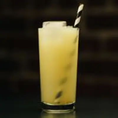 Momisette cocktail in a Collins glass with ice and a black-and-white straw