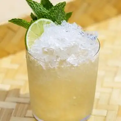 Tia Mia cocktail served in a rocks glass with crushed ice and a lime wheel and mint garnish